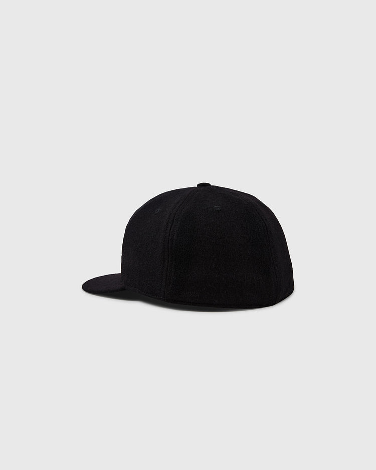 The University of Colorado 1924 Vintage Ballcap by EFF is shown on a light grey background, back and side view. This plain black cap has a flat brim with no visible logos, reflecting the classic style of historic team hats.