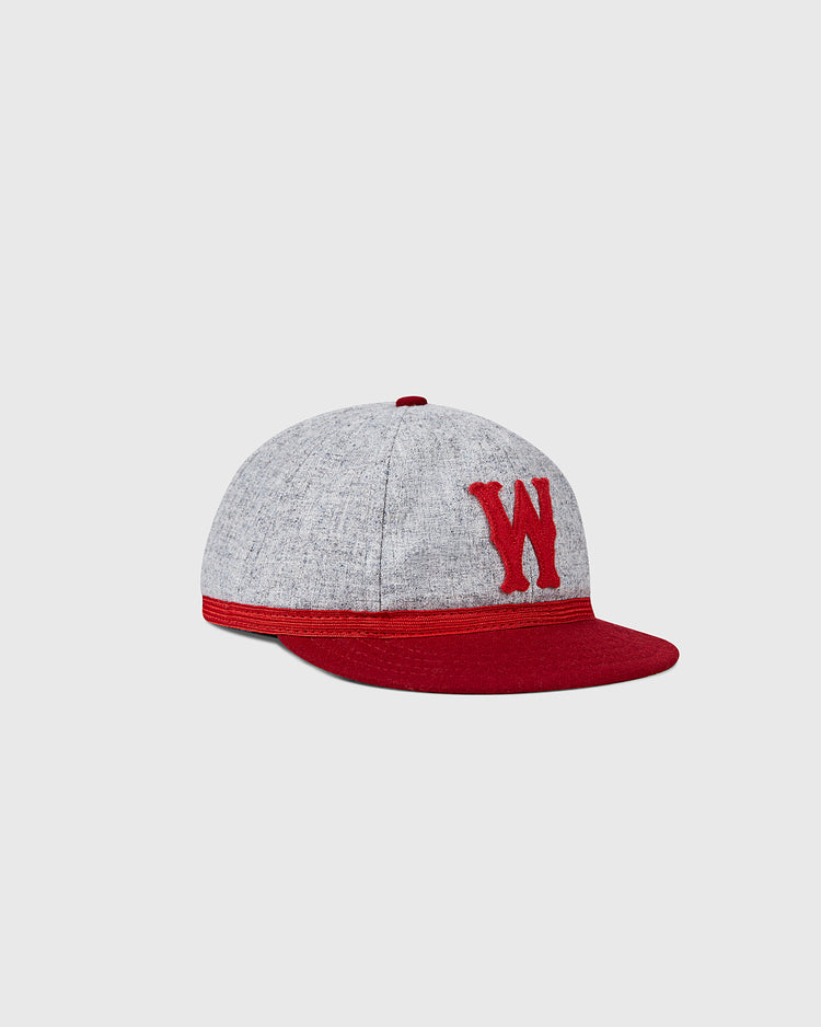 The EFF University of Wisconsin 1931 Vintage 8-Panel Ballcap features grey panels, a red brim, and a red embroidered W on the front, inspired by the classic collegiate style. Shown against a plain light grey background.