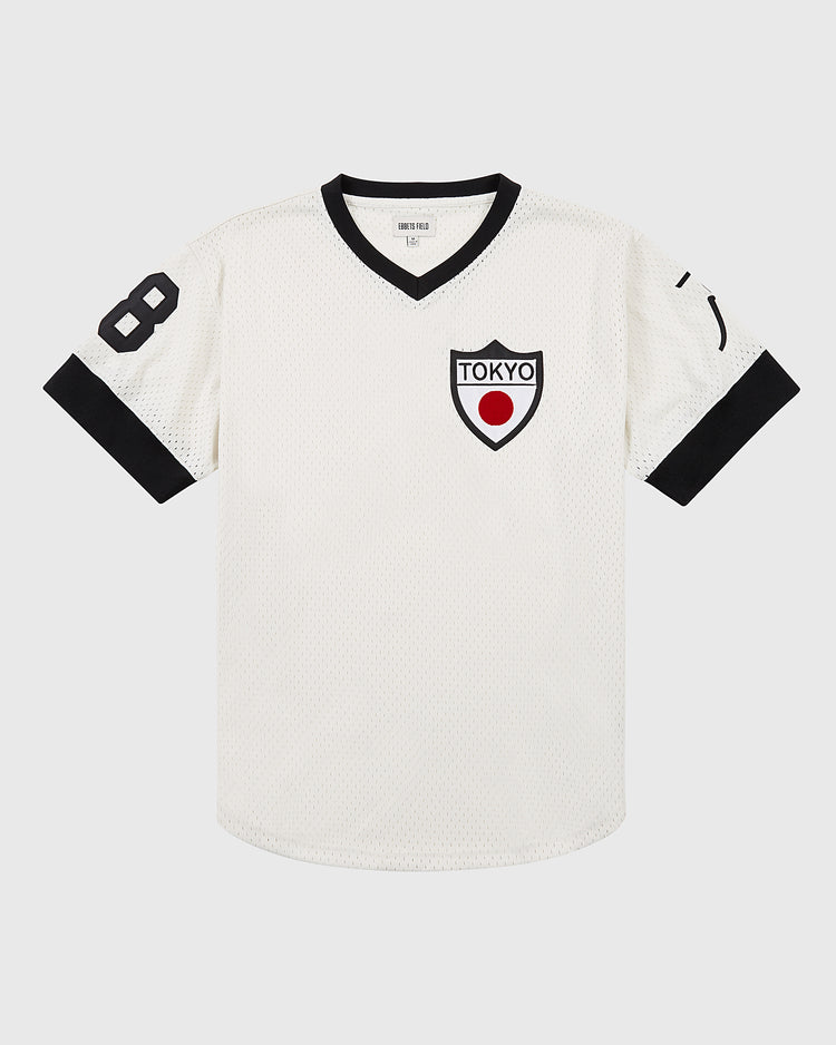 The Ebbets Field Tokyo Giants Mesh V-Neck Jersey features black trim, the number 8 on the right sleeve, and a Tokyo shield patch with red circle—a tribute to Victor Starffin and Japanese Baseball League heritage.