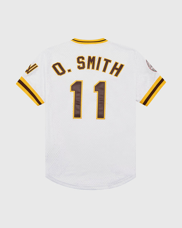 The Ebbets Field Ozzie Smith Walla Walla Padres Mesh V-Neck Jersey is a white jersey with yellow and brown trim, sleeve patches, and Smith’s name and number 11 on the back—honoring his Padres legacy.