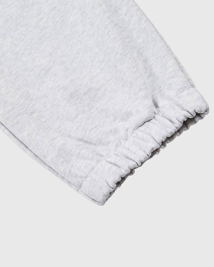 Close-up of the cuff on Ebbets Field’s Muhammad Ali Embroidered Heavyweight Cotton Terry Sweatpants in light gray, showing elastic ankle detailing against a plain white background.