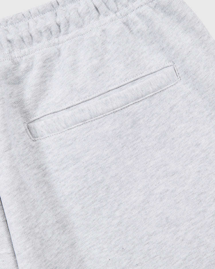 Close-up of the back pocket area of Ebbets Field Muhammad Ali Embroidered Heavyweight Cotton Terry Sweatpants in light gray, featuring an elastic waistband and single welt pocket—part of the Thrilla in Manila collection.