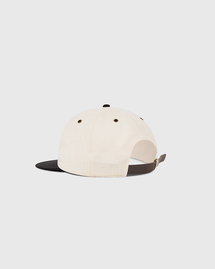 The Osaka Tigers Cotton Twill Ballcap by Ebbets Field is cream with a black brim, brown adjustable strap and metal buckle, two eyelets per side, and shown from the back on a plain white background.