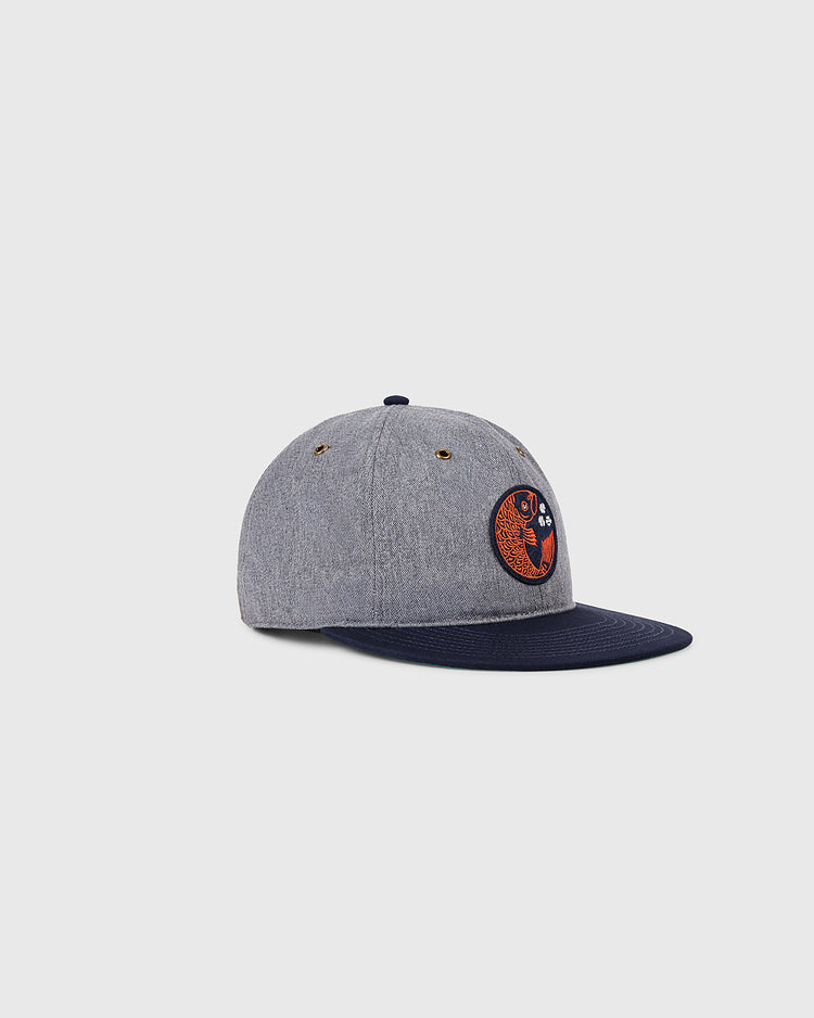 The Ebbets Field Hiroshima Carp Cotton Twill Ballcap features a gray crown, navy brim, and an embroidered orange and navy Hiroshima Carp patch, showcased on a plain light background.