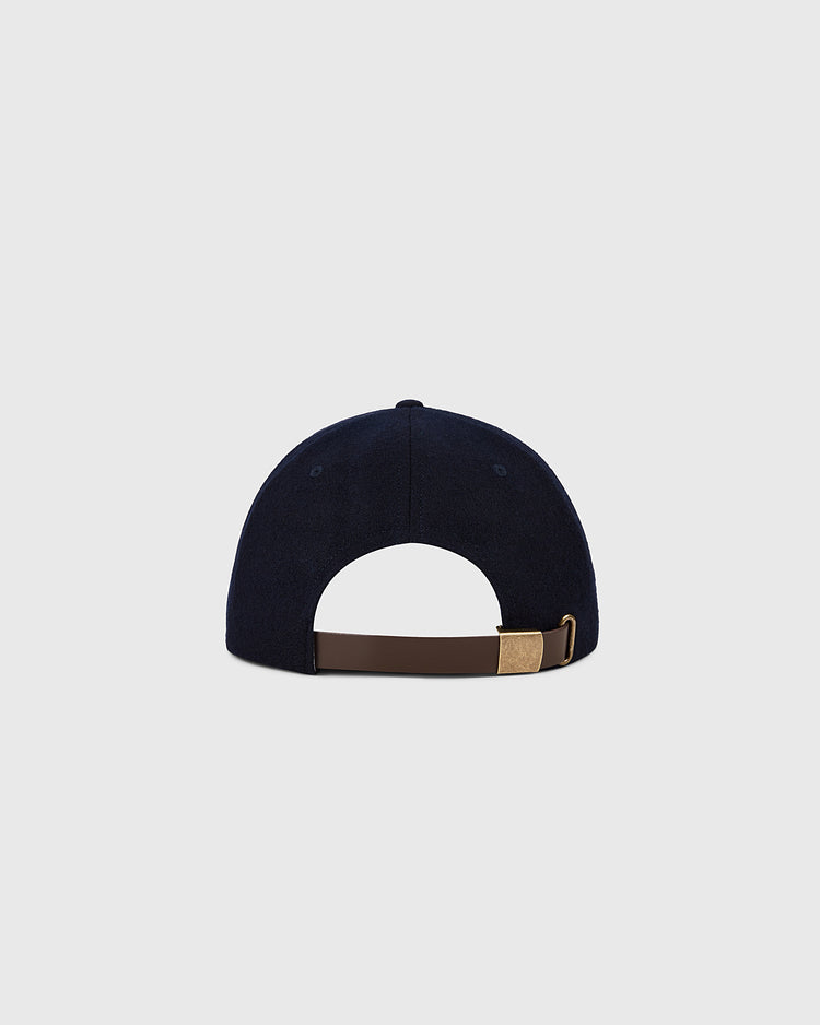 The Ebbets Field New York Yankees 1961 MLB Authentic Wool Ballcap from the Decade of Change Collection is shown from the back, with a brown adjustable strap, brass buckle, and a plain light gray background.