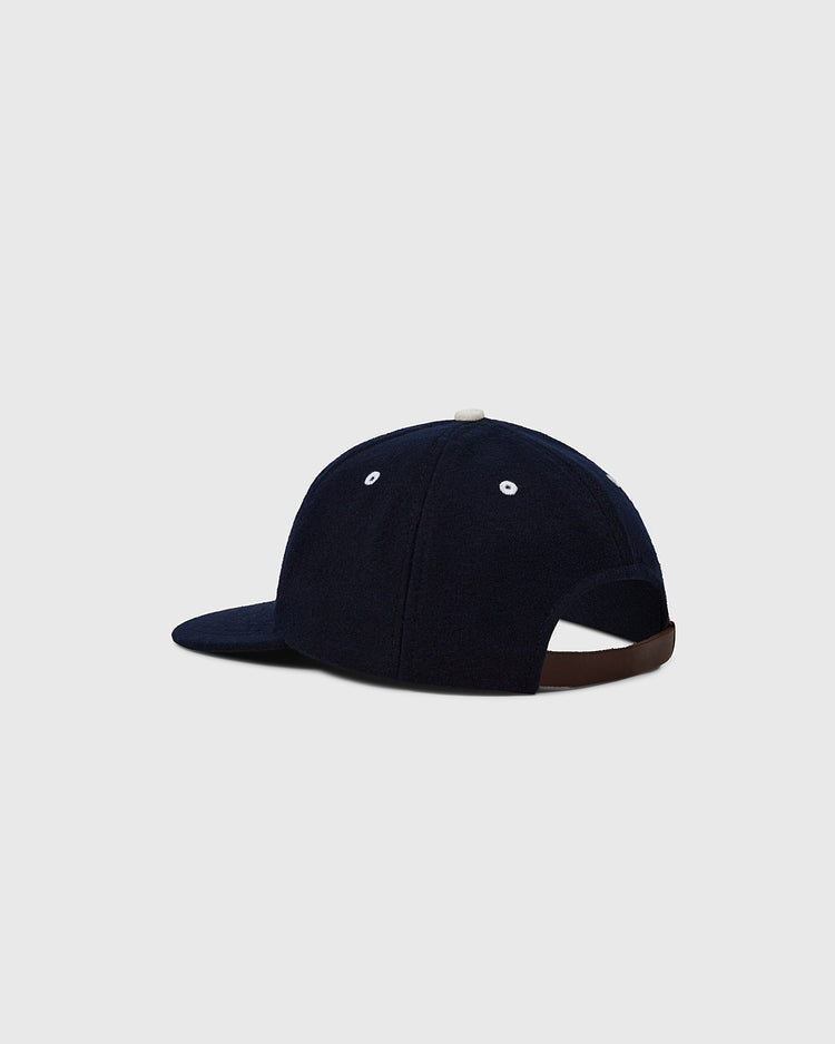 The EFF Los Angeles (PCL) 1954 Authentic Wool Ballcap in navy blue is shown from the back left, highlighting its brown adjustable strap and white eyelets against a plain light gray background.