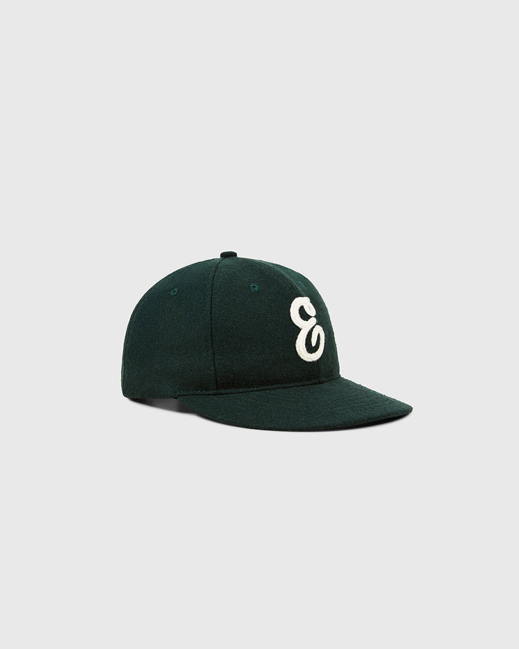 The Ebbets Field Felt 'E' Wool Ballcap is a dark green vintage baseball cap made from wool broadcloth, featuring a white stylized lowercase