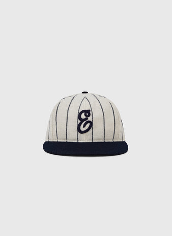The Ebbets Field Ebbets Felt 'E' Wool Pinstripe Ballcap features cream-colored wool with thin black pinstripes, a black brim, and a stylized black
