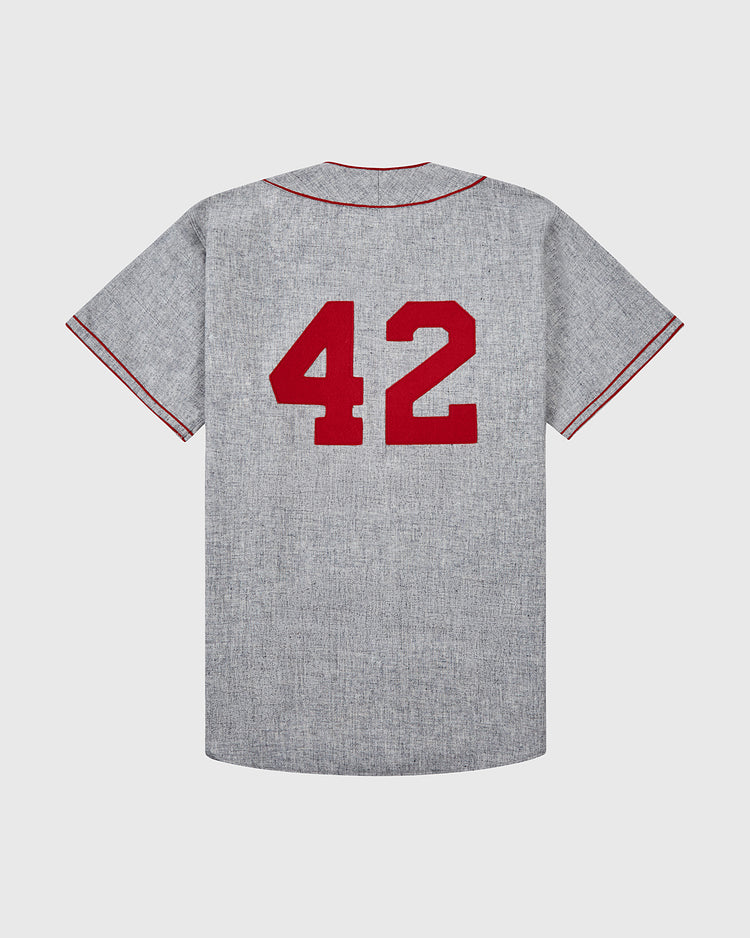 The Ebbets Field Aloha 100th Infantry 1942 Authentic Wool Road Baseball Jersey features gray wool, red sleeve and collar piping, an authentic Aloha logo, and a bold red number 42 on the back to honor the legendary battalion.