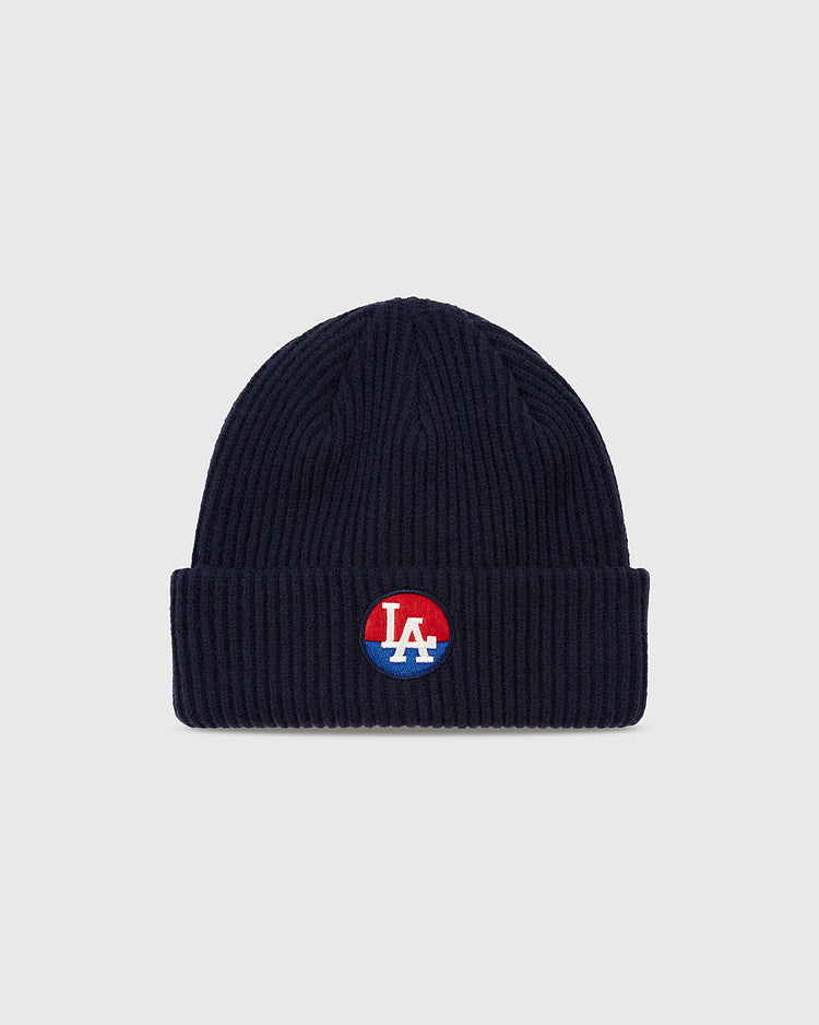 The Ebbets Field Los Angeles Angels (PCL) Patch Logo Ribbed Beanie features a navy blue ribbed knit, folded brim, and embroidered LA patch, perfect for Pacific Coast League and LA Angels fans.