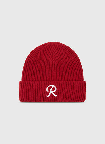The Seattle Rainiers Embroidered Logo Ribbed Beanie by Ebbets Field features a red knit design with a folded brim and a white embroidered