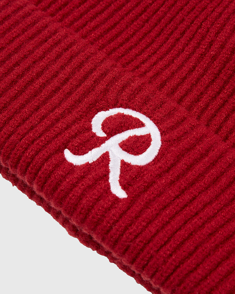 Close-up of a red ribbed knit Seattle Rainiers Embroidered Logo Beanie by Ebbets Field, featuring a white