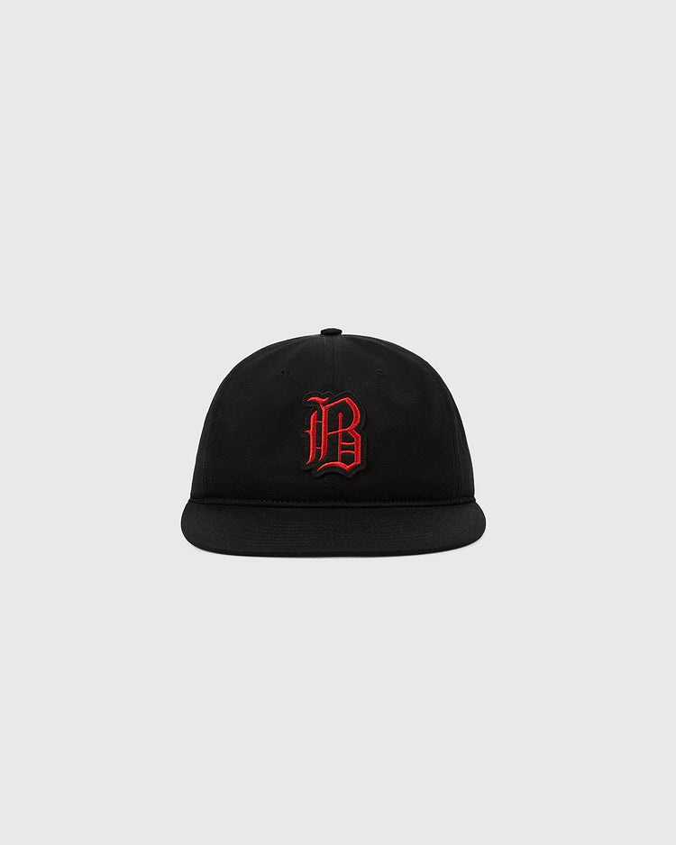 The Ebbets Field Birmingham Black Barons 1951 Cotton Twill Ballcap features a black flat brim and red gothic “B” embroidery, honoring the legendary Negro Leagues team and Satchel Paige, shown on a light gray background.