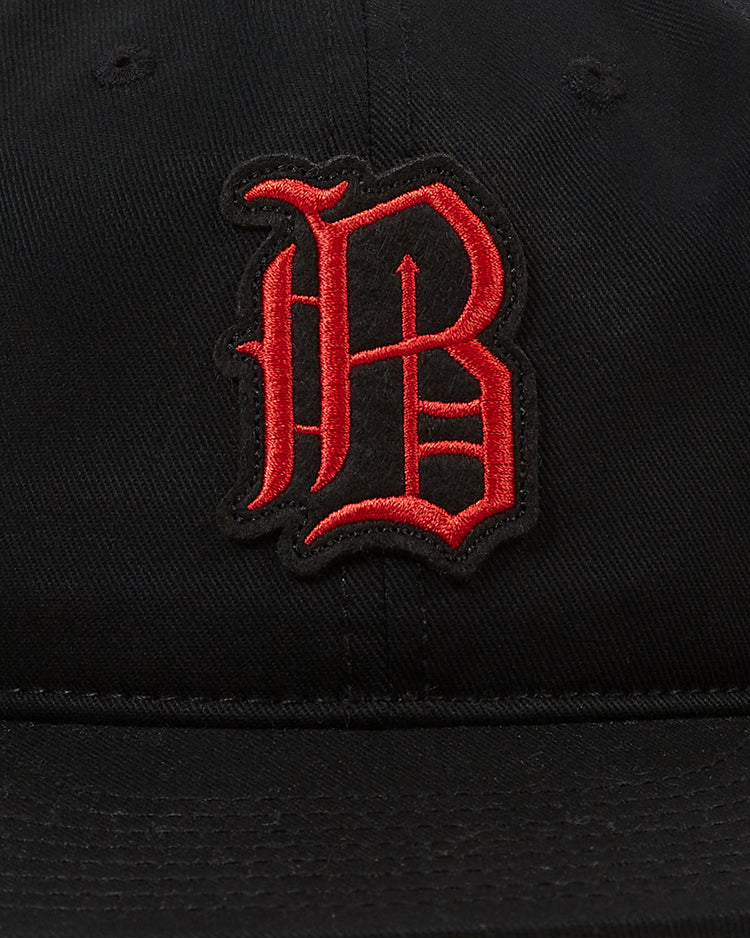 The Ebbets Field Birmingham Black Barons 1951 Cotton Twill Ballcap is a black cap featuring a bold, stylized red