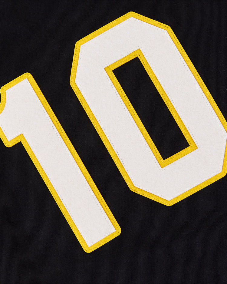 A close-up of the white number 10 with a yellow outline on black cotton twill, from the Osaka Tigers Baseball Jersey by Ebbets Field.