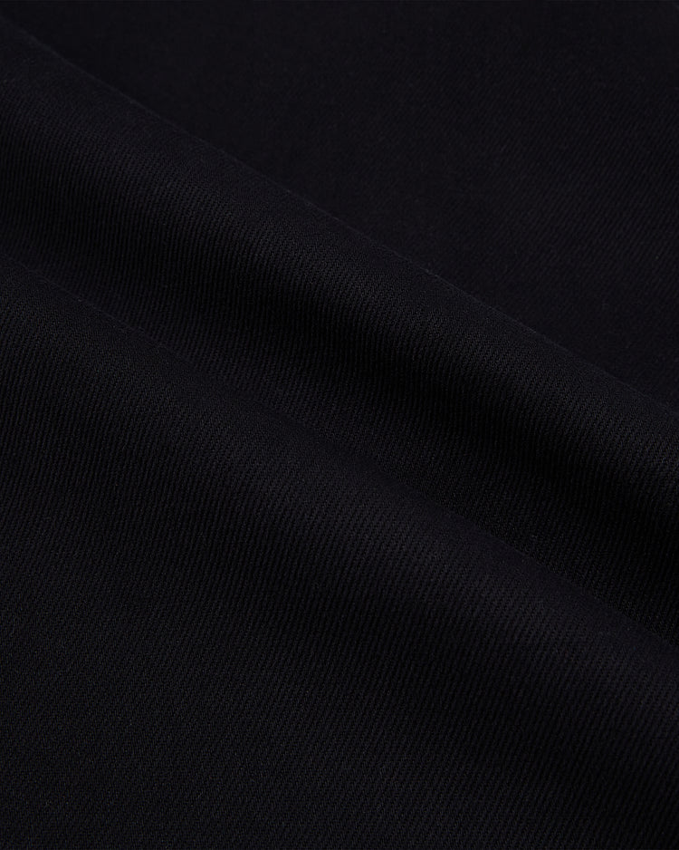 Close-up of Ebbets Field’s Osaka Tigers Cotton Twill Baseball Jersey, featuring black twill with a diagonal ribbed texture, soft folds, and a smooth surface, echoing the fine details of vintage baseball jerseys.