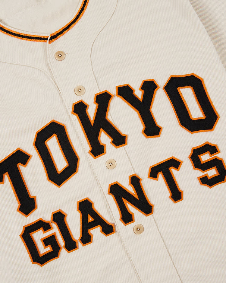 The Ebbets Field Tokyo Giants 1953 Cotton Twill Baseball Jersey features black and orange TOKYO GIANTS lettering, black and orange trim, and classic front buttons for a vintage baseball look.