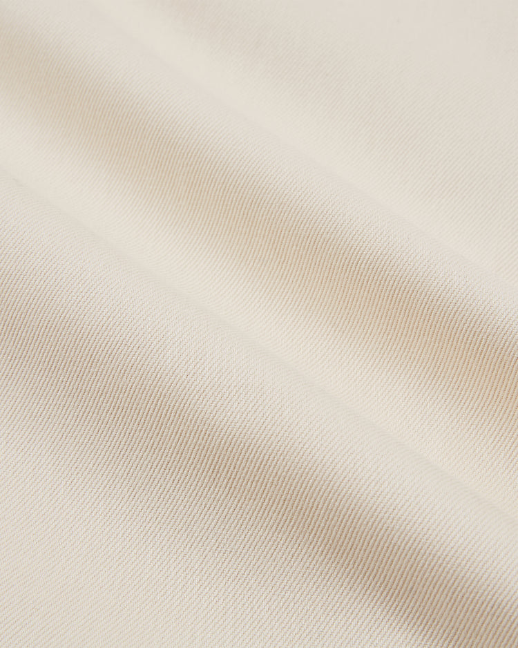 Close-up of the Tokyo Giants 1953 Cotton Twill Baseball Jersey by Ebbets Field, featuring off-white ribbed cotton twill with diagonal textured lines, soft sheen, and smooth folds reminiscent of a vintage baseball jersey.