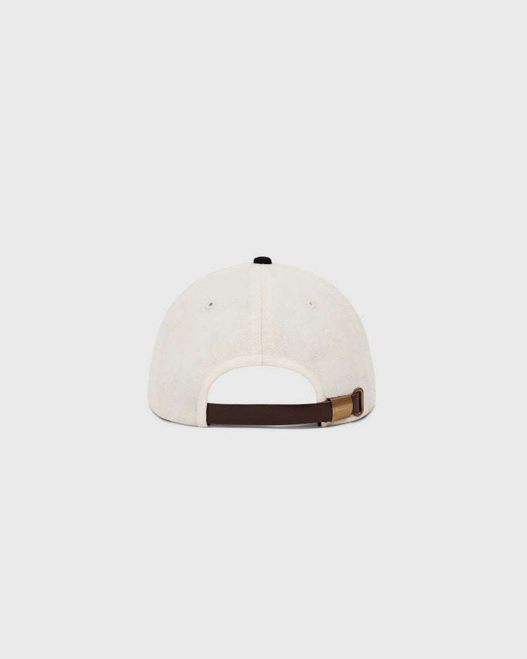 A white Muhammad Ali Vintage Inspired Wool Ballcap by Ebbets Field, shown from the back with a dark brown adjustable strap and brass fastener, subtly referencing the iconic Thrilla in Manila on a plain light background.