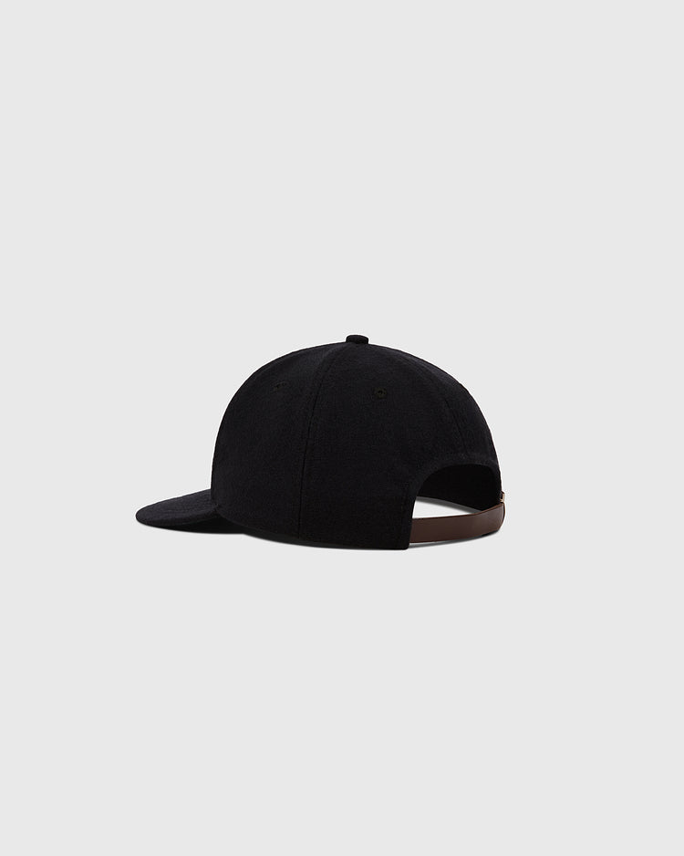 The Ebbets Field Muhammad Ali Vintage Inspired Wool Ballcap, shown from the back, features a curved brim and adjustable brown strap, standing out against a light gray background.