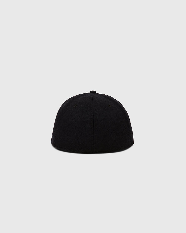 The Ebbets Field Sioux City Ghosts Vintage Inspired Wool Ballcap is displayed from the back on a light gray background, featuring a smooth, seamless black design with a rounded shape and no visible logo or adjustable strap.