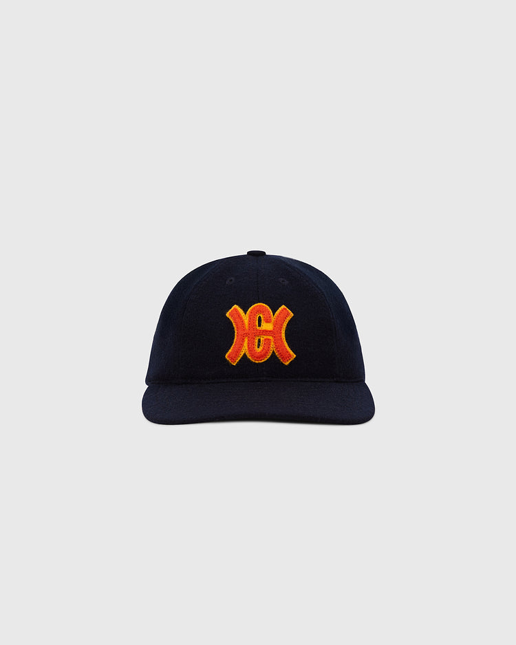 The Ebbets Field Hiroshima Carp 1959 Authentic 8-Panel Wool Ballcap is black with a curved brim and a bold yellow and red embroidered logo on the front, shown against a plain light gray background.