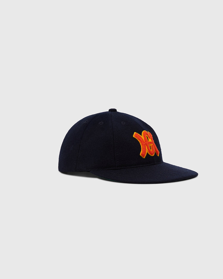 The Ebbets Field Hiroshima Carp 1959 Authentic 8-Panel Wool Ballcap in navy features an orange and yellow embroidered logo on the front, shown on a plain light gray background.