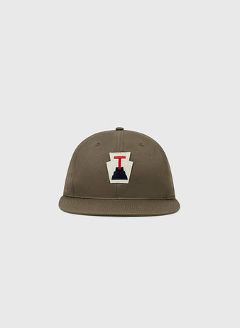 The Ebbets Field Tabasco Plataneros Cotton Twill Ballcap is a brown, flat-brim hat with a front patch showing a white background, navy shape, and red