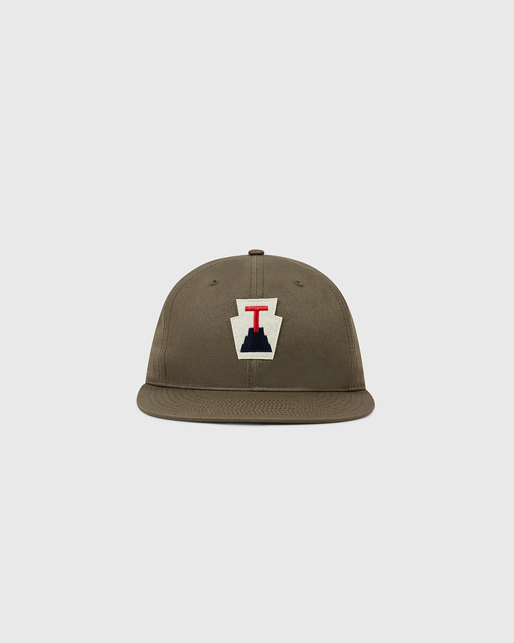 The Ebbets Field Tabasco Plataneros Cotton Twill Ballcap is a brown, flat-brim hat with a front patch showing a white background, navy shape, and red
