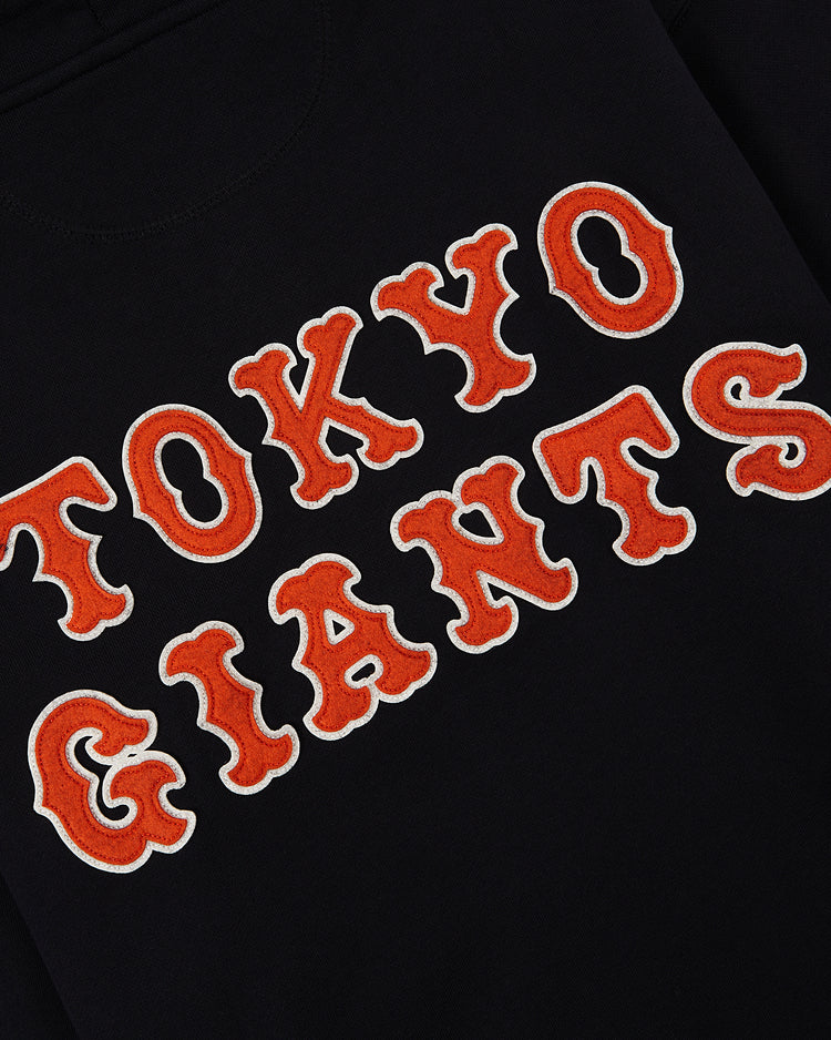 The Ebbets Field Tokyo Giants Heavyweight Cotton Terry Full-Zip Hoodie features black fabric with bold orange and white varsity-style