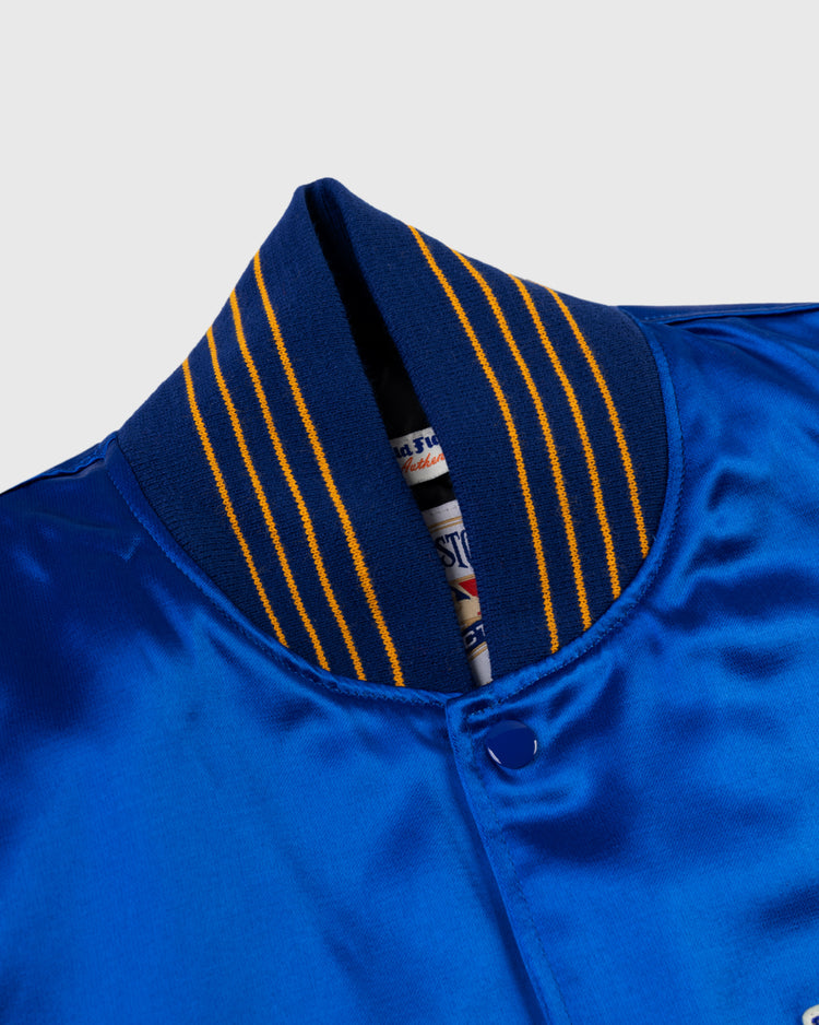 Close-up of the EFF Seattle Pilots 1969 Authentic All Satin Varsity Jacket, featuring a shiny blue finish, ribbed navy collar with yellow stripes, and a partially visible inside label beneath the collar.