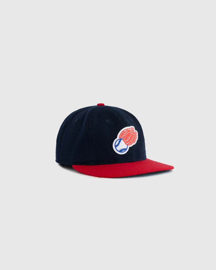 The EFF Rochester Red Wings 1950 Authentic Wool Ballcap features navy wool, a red brim and button, and an embroidered patch of a red glove holding a baseball on the front, displayed against a plain light gray background.