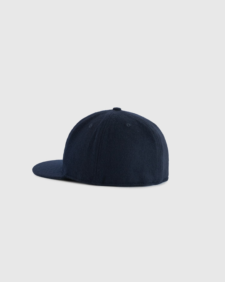The EFF Tabasco Plataneros 1964 Authentic Wool Ballcap is a plain dark navy cap with a rounded crown and flat brim, shown from the back and side on a light gray background. No logos or designs are visible.