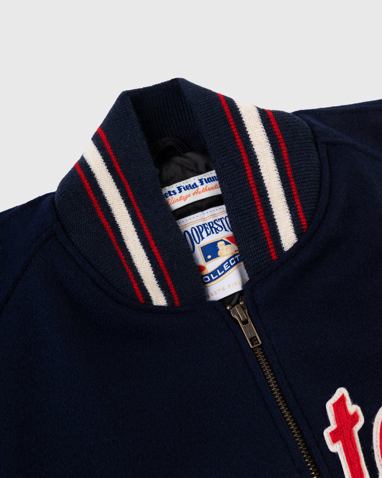 Close-up of the EFF Washington Senators 1966 Authentic All Wool Varsity Jacket collar in navy with white and red stripes, front zipper, Cooperstown Collection label inside, and partial white and red lettering on the chest.