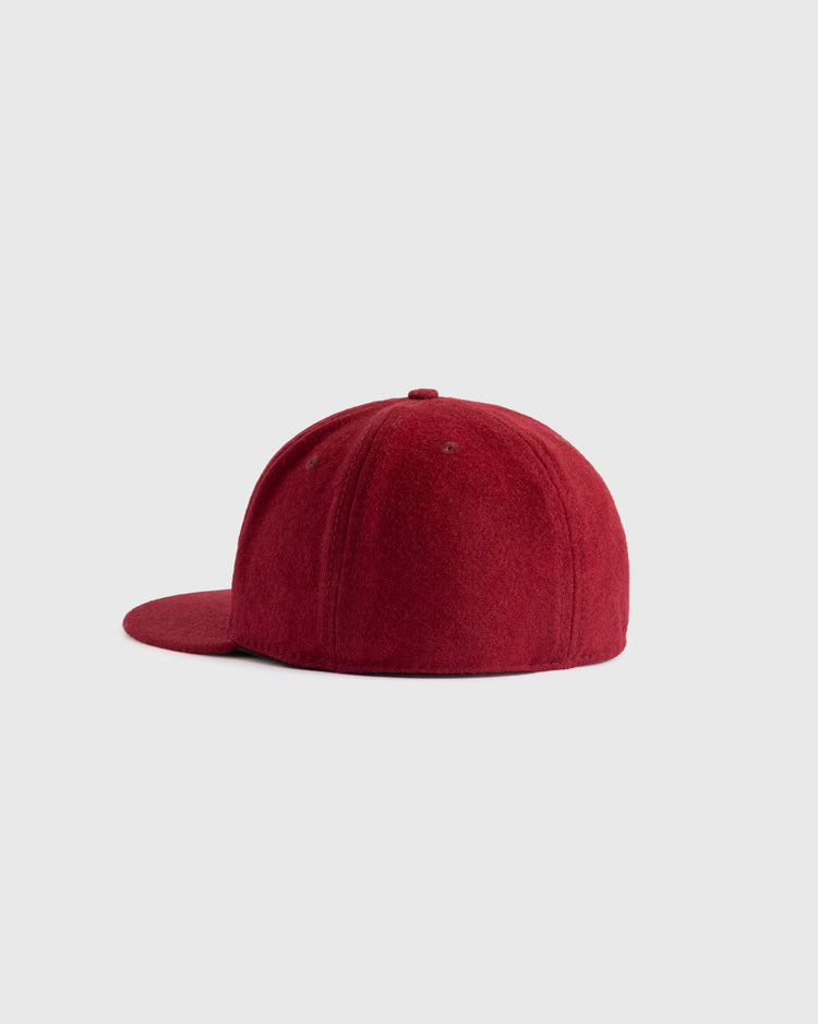 The EFF Brooklyn College 1959 Authentic Wool Ballcap, shown from the side on a light gray background, features a red flat brim and an authentic felt logo.