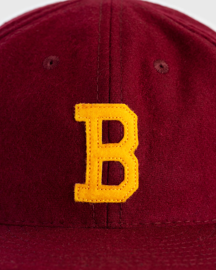 A close-up of the EFF Brooklyn College 1959 Authentic Wool Ballcap, showcasing a large yellow felt B logo on the front.