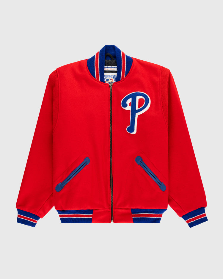 The EFF Philadelphia Phillies 1949 Authentic All Wool Varsity Jacket is bright red with blue and white striped cuffs, collar, hem, a blue and white P patch on the chest, and blue-trimmed pockets. Shown on a light gray background.