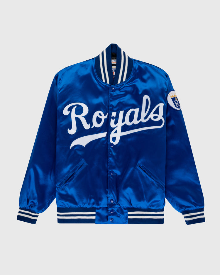 The EFF Kansas City Royals 1969 Authentic All Satin Varsity Jacket features royal blue satin, white Royals script on the front, striped ribbed trim, and a sleeve patch inspired by the original 1969 Royals jacket.