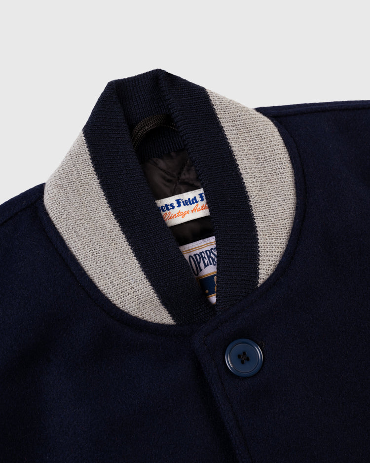 Close-up of the EFF Boston Red Sox 1938 Authentic Wool & Suede Leather Varsity Jacket, showing a ribbed light gray and navy striped collar, blue button, thick textured fabric, and a partially visible inner label.