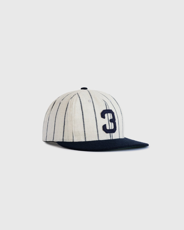 The Babe Ruth 1932 Signature Series Wool Ballcap by Ebbets Field Flannels features white wool with black pinstripes, a black visor, and a bold black number 3 on the front, displayed against a plain light gray background.