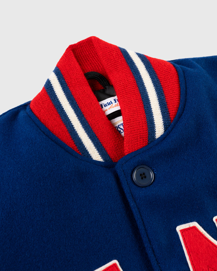 Close-up of the collar and top button of the EFF New York Giants 1932 Authentic All Wool Varsity Jacket, featuring a red, white, and blue striped ribbed collar with a partially visible label inside this classic team jacket.