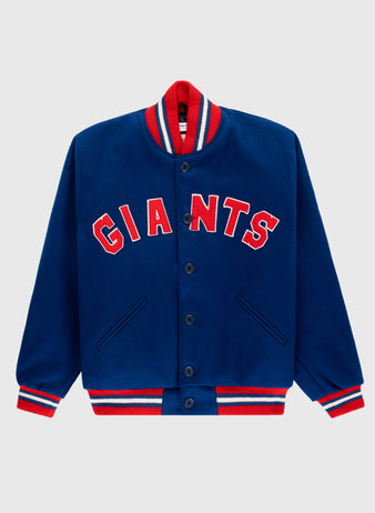 The EFF New York Giants 1932 Authentic All Wool Varsity Jacket features a blue body, red and white striped collar, cuffs, and hem, front buttons, two pockets, and GIANTS in bold red letters on the chest.