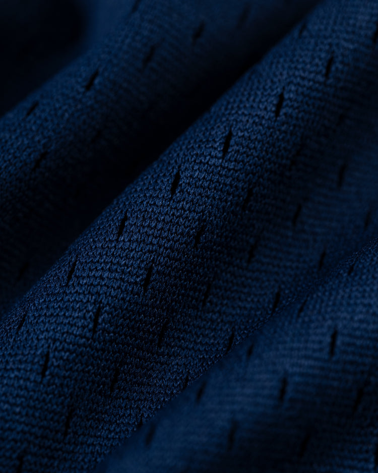 Close-up of the EFF Homestead Grays Mesh V-Neck Jersey, featuring dark blue perforated fabric with diagonal linesâa throwback design inspired by baseball history and the legacy of the Homestead Grays.