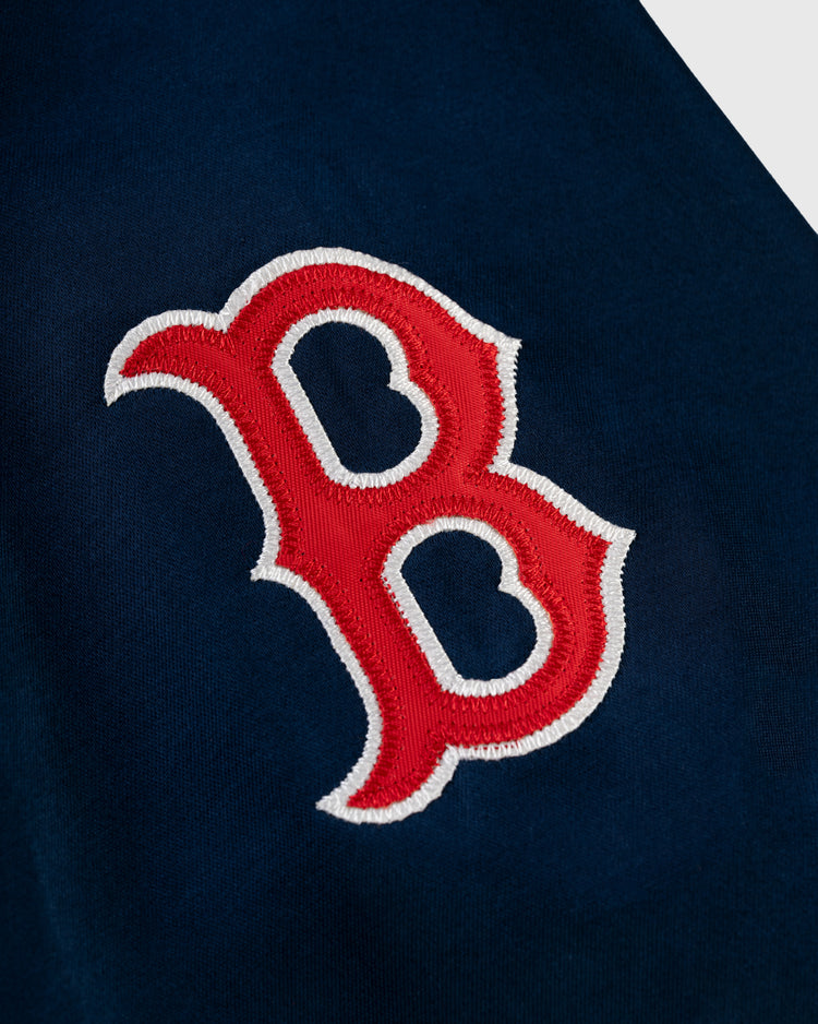A red and white embroidered letter B logo appears on dark blue fabric, evoking the classic style of the EFF Boston Red Sox 1967 Satin Windbreaker Jacket.