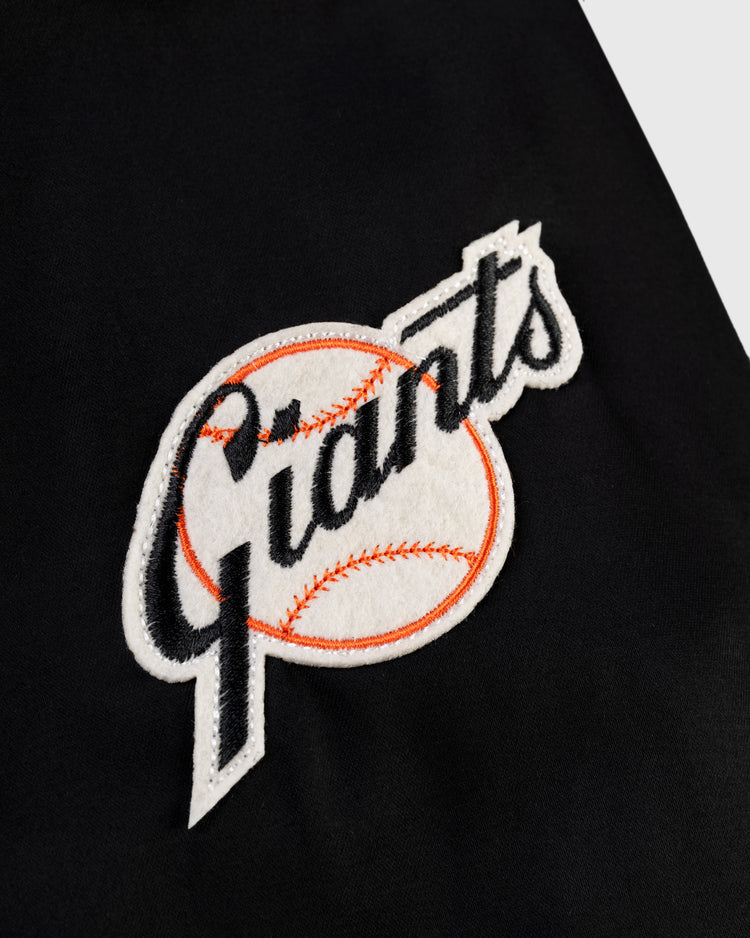 A black fabric patch with “Giants” in stylized black text over an orange-stitched baseball, inspired by the New York Giants and ideal for pairing with the EFF New York Giants 1954 Satin Windbreaker Jacket.