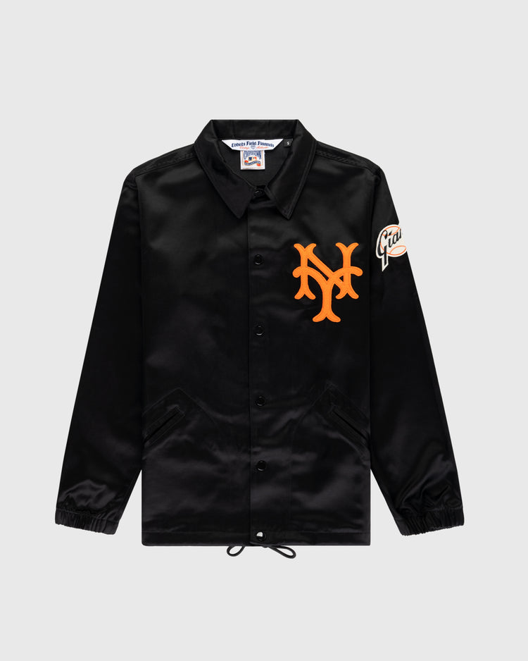 The EFF New York Giants 1954 Satin Windbreaker Jacket features a black button-up design with an orange NY logo on the chest, a Giants sleeve patch, collar, elastic cuffs, and a drawstring hem for authentic retro MLB style.