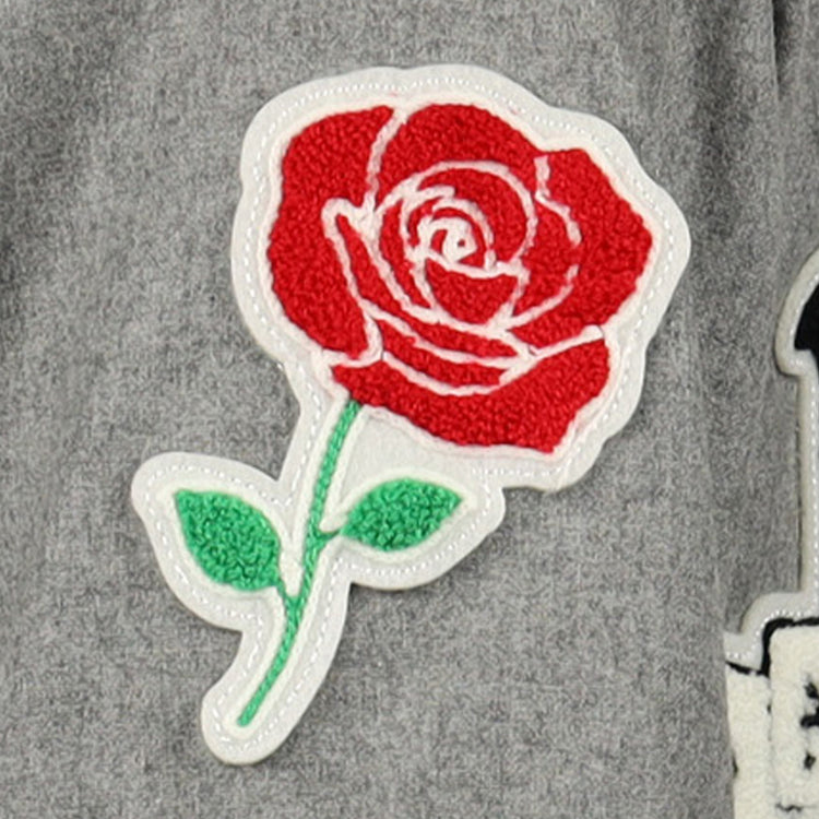 A red and white rose patch with green leaves is sewn onto a gray wool EFF New York Black Yankees Vintage Inspired Replica Jersey, honoring the legacy of this historic Negro National League team.