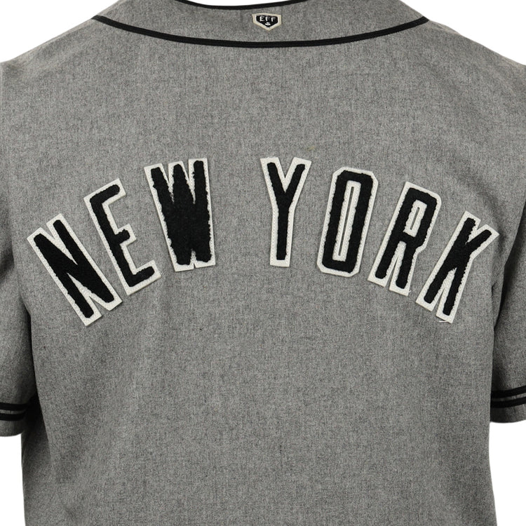 A close-up of the EFF New York Black Yankees Vintage Inspired Replica Wool Jersey, featuring NEW YORK in bold black and white letters, echoing the classic style from Negro National League baseball history.