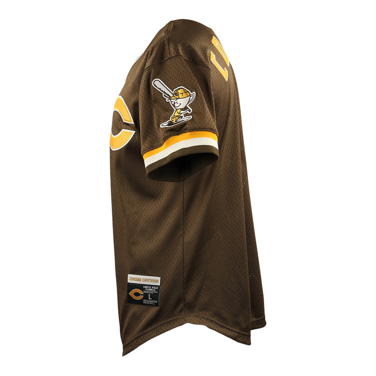 Side view of the Cordoba Cafeteros EFF DNA Replica V-Neck Mesh Jersey by EFF, featuring brown mesh, yellow and white sleeve stripes, cartoon batter patch, large chest “C,” and Cooperstown Collection tag—honoring Mexican baseball history.