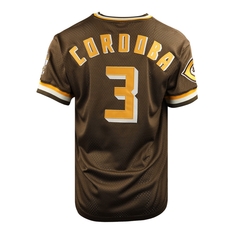 The EFF Cordoba Cafeteros DNA Replica V-Neck Mesh Jersey is a brown baseball jersey with gold and white trim, featuring CORDOBA and the number 3 in gold on the back, plus a Cafeteros legacy patch on the left sleeve, inspired by Mexican pro baseball.